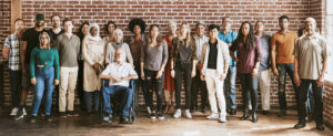 A group of different people including persons with disabilities