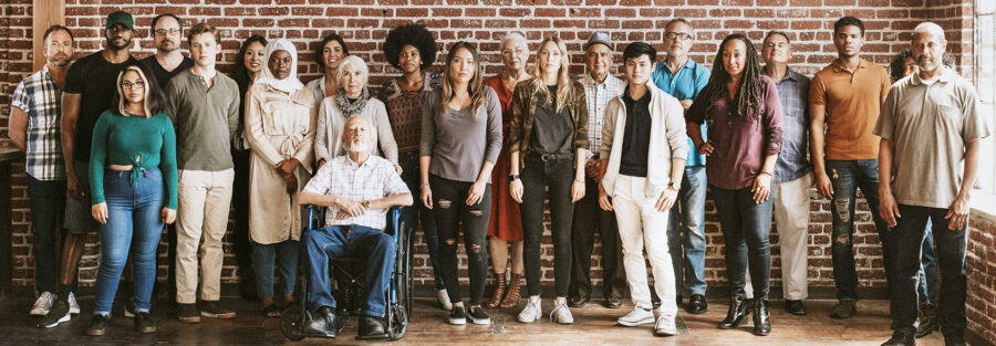 A group of different people including persons with disabilities