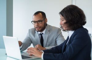 BIPOC man and a Caucasian woman having a cooperative conversation