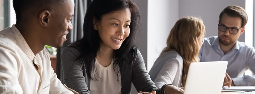 Two pairs of diverse men and women having cooperative work conversations